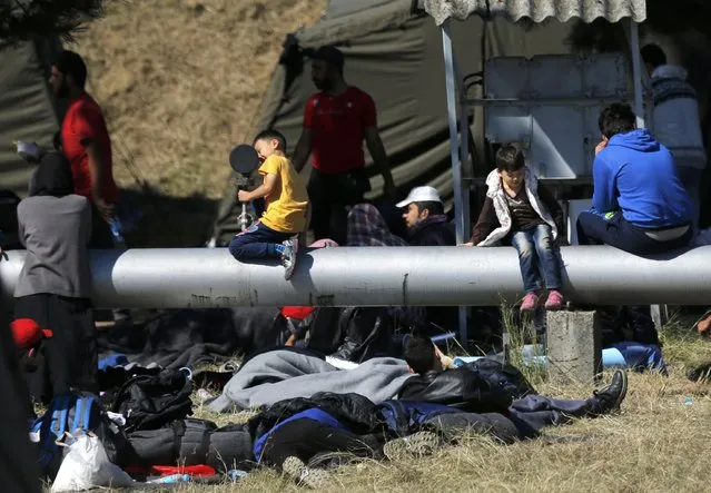 Migrant children play as others rest in a camp in Opatovac, Croatia September 21, 2015. (Photo by Antonio Bronic/Reuters)