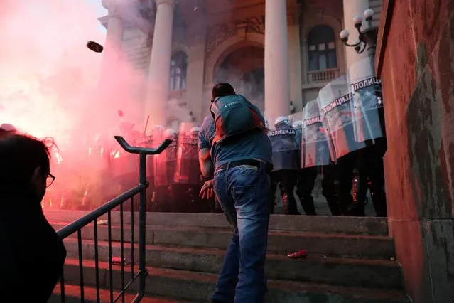 Demonstrators clash with police officers during an anti-government rally, amid the spread of the coronavirus, in front of the parliament building in Belgrade, Serbia, July 8, 2020. (Photo by Marko Djurica/Reuters)
