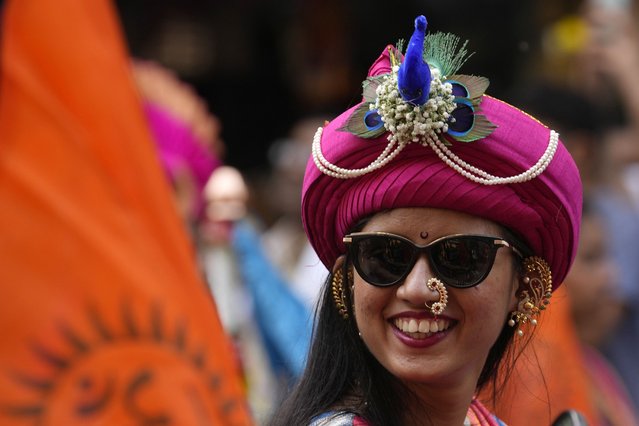 A woman dressed in traditional attire participates in a procession to mark Gudi Padwa or the Marathi New Year in Mumbai, India, Sunday, March 30, 2025. (Photo by Rajanish Kakade/AP Photo)
