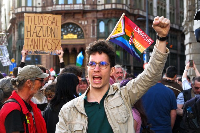 A participant shouts an anti-government slogan as protesters march close to the Erzsebet (Elisabet) Bridge in the heart of Budapest on April 22, 2025 in response to the Hungarian parliament adopting the change the constitution on April 14, 2025. Hungarian lawmakers on April 14 overwhelmingly backed constitutional changes targeting the country's LGBTQ community and dual nationals, the latest step to strengthen longtime nationalist Prime Minister Orban's self-styled “illiberal” brand of democracy. (Photo by Attila Kisbenedek/AFP Photo)