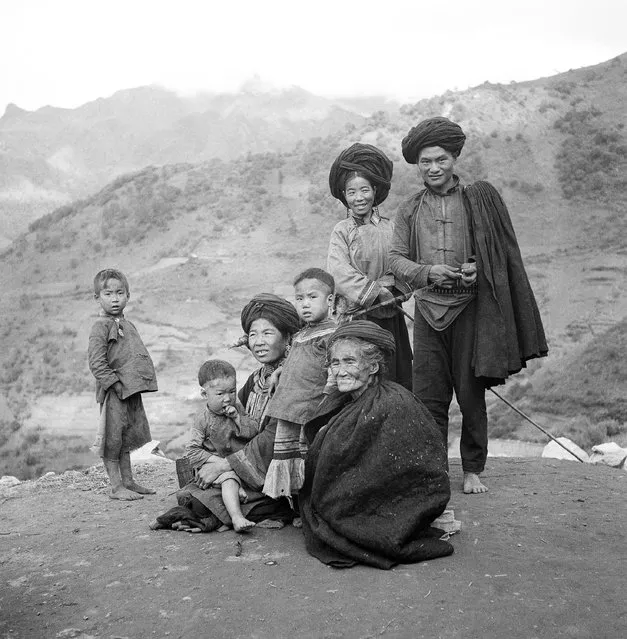 A Lolo family pose for photographer, who accompanied the American rescue party near Sichang, in Sikang Province on October 31, 1946. Officers of the American Graves Registration Section are attempting to trace and rescue possible survivors of a B-29 which crashed during a flight over “The Hump”. (Photo by AP Photo)