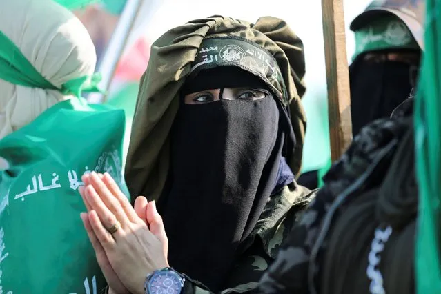 A woman attends a rally by Palestinian Hamas supporters marking the 35th anniversary of the movement's founding, in Gaza City on December 14, 2022. (Photo by Ibraheem Abu Mustafa/Reuters)