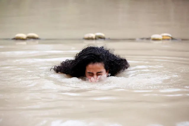 An Orthodox Christian pilgrim is baptized, as pilgrims arrived ahead of Epiphany Day at the Qasr al Yahud baptism site, near the West Bank city of Jericho, 17 January 2018. The baptism site is where, according to tradition, Jesus was baptized by John the Baptist. Christian tradition marks this site as the place of the “spiritual birth” of Jesus as opposed to his physical birth. (Photo by Abir Sultan/EPA/EFE)