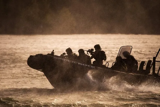 Special Forces (Hunter force) of Austrian Armed Forces arrive on a speedboat before entering a ship during a military exercise for the European Union Naval Force Mediterranean (EUNAVFOR MED) operation SOPHIA at the Danube River in Vienna, Austria, 19 September 2016. According to Austrian Armed Forces spokesman, up to 30 Special Forces soldiers will be dispatched for operation SOPHIA in 2017. The operation, with 24 participating nations, aims at fighting migrant traffickers as well as rescuing refugees in distress at the Mediterranean sea. (Photo by Christian Bruna/EPA)