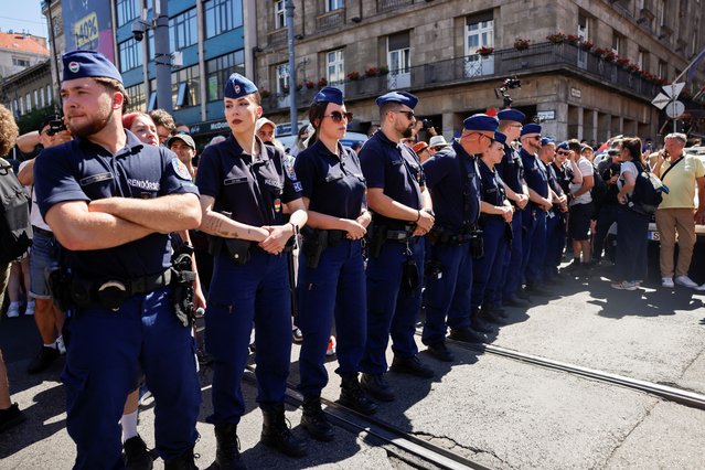 Police officers stand guard as people attend The Budapest Pride March in Budapest, Hungary, on June 28, 2025. (Photo by Lisa Leutner/Reuters)