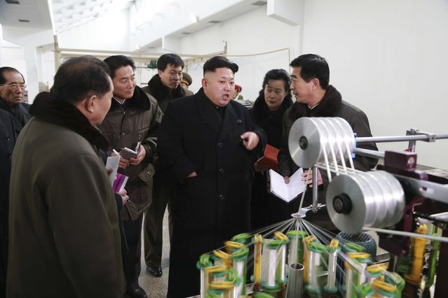 North Korean leader Kim Jong Un (3rd R) gives field guidance at the Kim Jong Suk Pyongyang Textile Mill in this undated photo released by North Korea's Korean Central News Agency (KCNA) in Pyongyang December 20, 2014. (Photo by Reuters/KCNA)