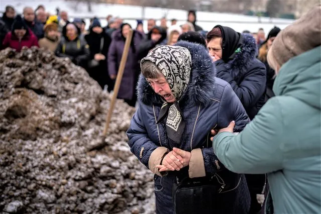 Relatives react at the grave of Yevhen Zapotichnyi, a Ukrainian military servicemen who were killed in the east of the country, during his funeral in Lviv, Ukraine, Tuesday, February7, 2023. (Photo by Emilio Morenatti/AP Photo)