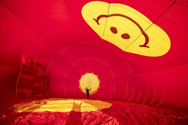 A pilot checks rigging inside a balloon envelope as five hot air balloons prepare for a sunrise launch over Gilcombe Farm in Bruton, Somerset on Wednesday, June 11, 2025 to announce Show of Hands – the UK's first fully community-built music and arts festival. (Photo by Ben Birchall/PA Wire)