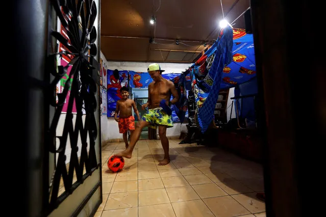 A father plays soccer with his son in the living room of his home, in Havana, Cuba, 01 September 2020. Havana is submitted from this 01 September and for at least 15 days to the most restrictive measures imposed by the Government of Cuba since the beginning of the coronavirus pandemic, which include a curfew from 7:00 p.m., the prohibition to leave the city and hefty fines for defaulters. (Photo by Ernesto Mastrascusa/EPA/EFE)