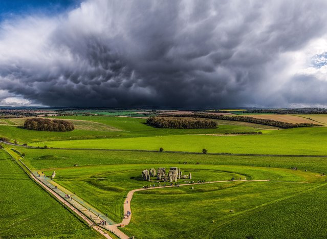 A dark storm cloud approaches Stonehenge in Wiltshire on Monday afternoon, April 15, 2024, during a day of mixed weather, viewed from the air with a drone. (Photo by Nick Bull/Picture Exclusive)