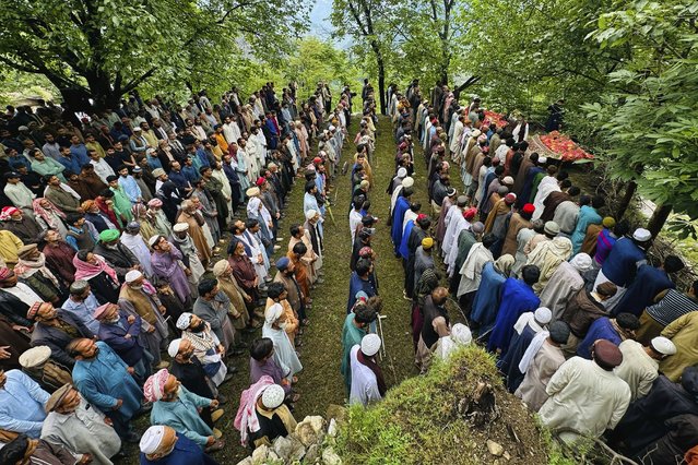 People attend funeral prayers of the victims of a cloudburst incident, sudden intense downpours, in Naryan Behak village near Muzaffarabad, the main town of Pakistan's controlled Kashmir, Friday, August 15, 2025. (Photo by M.D. Mughal/AP Photo)