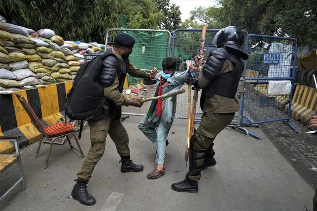 Police detain a supporter of former Prime Minister Imran Khan during a search operation in the Khan's residence, in Lahore, Pakistan, March 18, 2023. Pakistani police stormed former Prime Minister Khan's residence in the eastern city of Lahore on Saturday and arrested 61 people amid tear gas and clashes between Khan's supporters and police, officials said. (Photo by K.M. Chaudary/AP Photo)