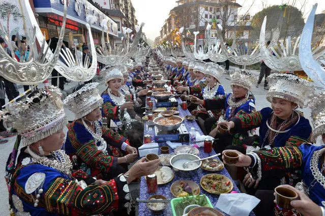 Women of Miao ethnic group wearing traditional costumes have a long table banquet to celebrate the Miao New Year on November 19, 2020 in Leishan County, Qiandongnan Miao and Dong Autonomous Prefecture, Guizhou Province of China. (Photo by Qiao Qiming/VCG via Getty Images)