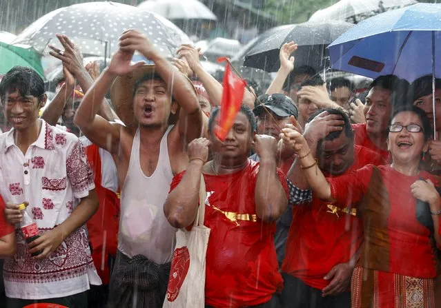 Supporters celebrate as they wait for official results from the Union Election Commission in front of National League for Democracy Party (NLD) head office at Yangon, November 9, 2015. (Photo by Soe Zeya Tun/Reuters)