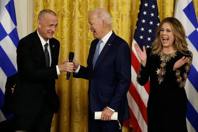 U.S. President Joe Biden joins actors Tom Hanks and Rita Wilson after Wilson sang four songs during a reception celebrating Greek Independence Day in the East Room of the White House on March 29, 2023 in Washington, DC. Greeks commemorate their war of independence from the Ottoman Empire, waged 1821-1829, on March 25. Married since 1988, Hanks and Wilson are Greek citizens. (Photo by Chip Somodevilla/Getty Images)