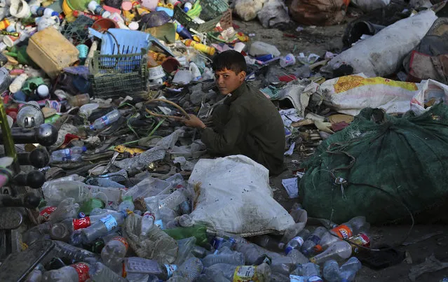 An Afghan boy sorts used plastic at a recycling unit in Kabul, Afghanistan, Friday, August 16, 2019. (Photo by Rafiq Maqbool/AP Photo)