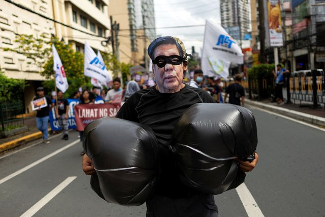An activist wearing a costume depicting Philippine President Ferdinand “Bongbong” Marcos Jr., as a robber marches during a halloween-themed protest against government corruption in Manila, Philippines, on October 31, 2025. (Photo by Eloisa Lopez/Reuters)