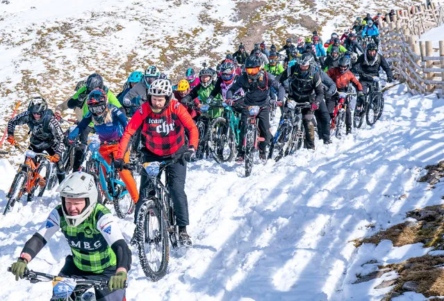 Cyclists take part in MacAvalanche, a mass start mountain bike race through the snow, descending over 900m from the summit of Aonach Mor in the Nevis Range near Fort William, Scotland on Saturday, April 15, 2023. (Photo by Jane Barlow/PA Images via Getty Images)