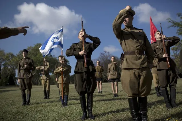 Israeli youths from a group called WWII Reenactment Club rehearse before a ceremony marking the Victory Day, in Ashdod, Israel, Wednesday, May 9, 2018. Israeli World War II veterans from the former Soviet Union marched together with their families across the country Wednesday to celebrate the 73rd anniversary of the allied victory over Nazi Germany in 1945. (Photo by Oded Balilty/AP Photo)