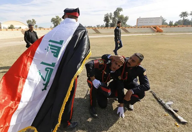 Officers react at their graduation ceremony during Iraqi Army Day anniversary celebration in Baghdad January 6, 2015. (Photo by Thaier al-Sudani/Reuters)