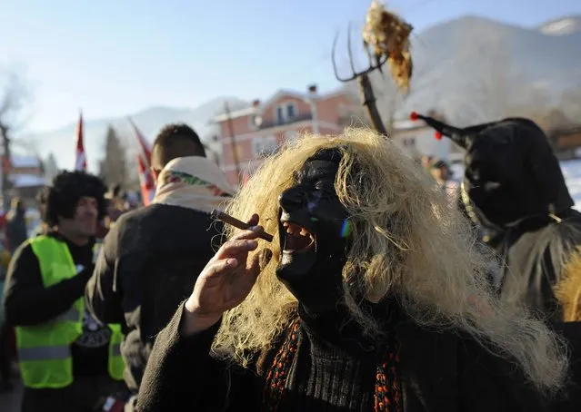 Revellers participate in a parade on the street during a carnival in the village of Vevcani, south of the Macedonian capital of Skopje, January 13, 2015. (Photo by Ognen Teofilovski/Reuters)