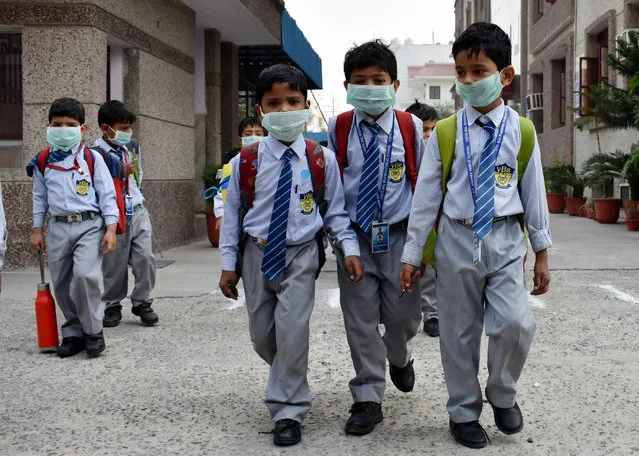 School students have started wearing face masks to school after pollution levels increased after Diwali on November 4, 2016 in Ghaziabad, India. The toxic smog choked the capital and the surrounding areas with visibility reducing to the second lowest recorded in at least 10 years for November and one monitoring agency showing that the city's air quality index had again gone off the scale at 500+, a level it had reached a day after Diwali. (Photo by Sakib Ali/Hindustan Times via Getty Images)