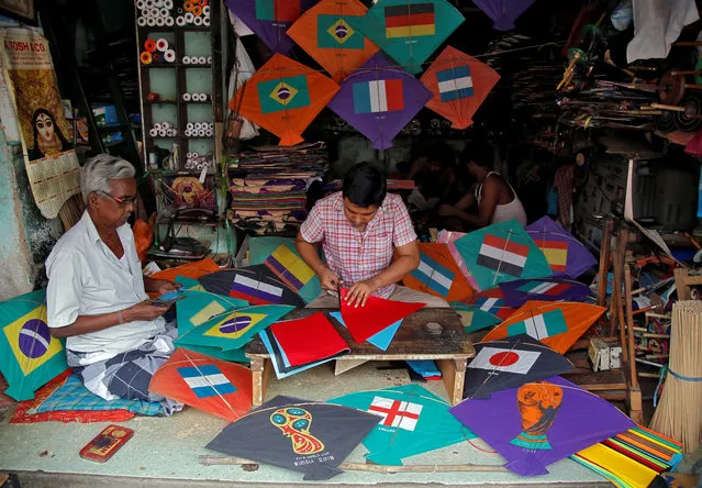 Kite-makers make kites with pictures of the national flags of the countries participating in the upcoming FIFA World Cup in Russia, at a workshop in Kolkata, June 5, 2018. (Photo by Rupak De Chowdhuri/Reuters)