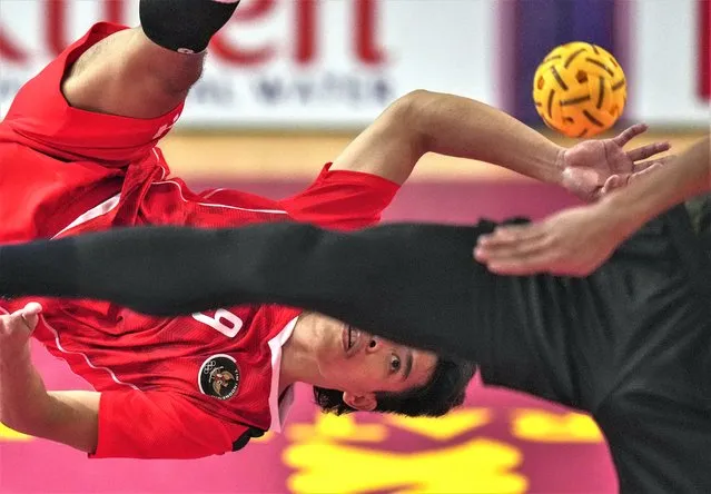 Indonesia's Rusdi Rusdi, left, kicks a ball against Malaysia's Muhammad Noraizat during the men's team doubles sepaktakraw final match at the 32nd Southeast Asian Games in Phnom Penh, Cambodia, Monday, May 15, 2023. (Photo by Tatan Syuflana/AP Photo)