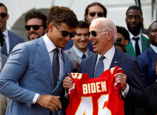 U.S. President Joe Biden reacts as Quarterback Patrick Mahomes and Tight End Travis Kelce present him with a personalized jersey of the Kansas City Chiefs during the team's visit to the White House to celebrate their championship season and victory in Super Bowl LVII, in Washington, U.S., June 5, 2023. (Photo by Evelyn Hockstein/Reuters)