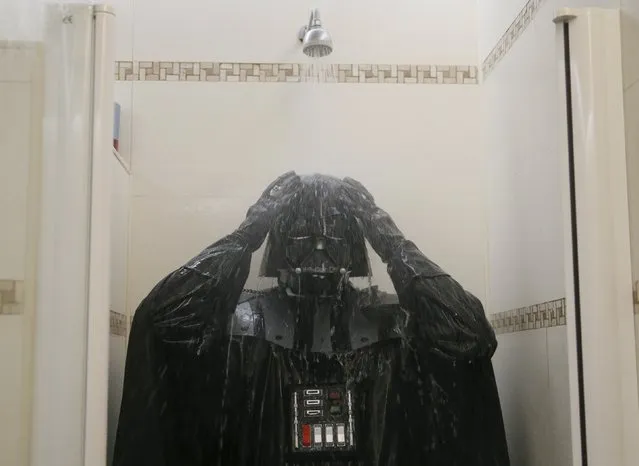 Darth Mykolaiovych Vader, who is dressed as the 'Star Wars' character Darth Vader, poses for a picture as he takes a shower in a bathroom at his apartments in Odessa, Ukraine, December 4, 2015. (Photo by Valentyn Ogirenko/Reuters)