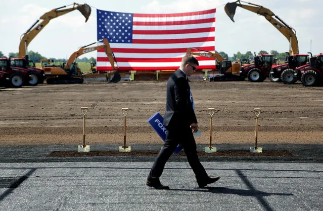 Heavy machinery and the American flag are seen before the arrival of U.S. President Donald Trump as he participates in the Foxconn Technology Group groundbreaking ceremony for its LCD manufacturing campus, in Mount Pleasant, Wisconsin, U.S., June 28, 2018. (Photo by Darren Hauck/Reuters)