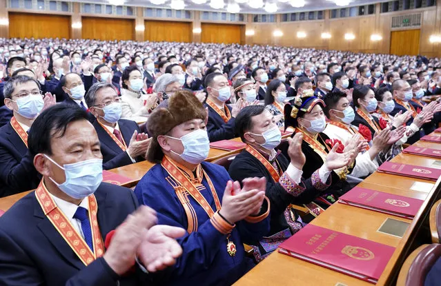 In this photo released by China's Xinhua News Agency, attendees applaud during a ceremony to mark the official end of extreme poverty in China held at the Great Hall of the People in Beijing, Thursday, February 25, 2021. The ruling Communist Party is celebrating the official end of extreme poverty in China with a propaganda campaign that praises President Xi Jinping's role, adding to efforts to cement his image as a history-making leader who is reclaiming his country's rightful place as a global power. (Photo by Yan Yan/Xinhua via AP Photo)