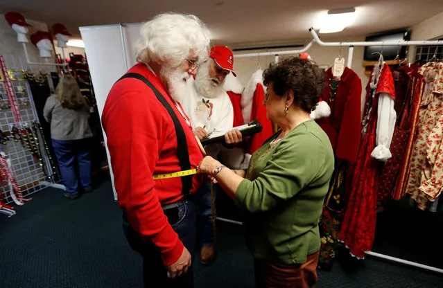 Santa Jack Bradley of Iron Ridge, Wisconsin is fitted for a suit following classes at the Charles W. Howard Santa Claus School in Midland, Michigan, U.S. October 28, 2016. (Photo by Christinne Muschi/Reuters)
