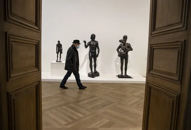 A visitor walks past sculptures by French artist Auguste Rodin displayed as part of the “Picasso – Rodin” exhibition at the Picasso Museum during a press visit, in Paris, France, 11 March 2021. The Picasso museum and the Rodin museum in Paris are hosting a joint retrospective exhibition of Rodin's and Picasso's work – although museums remain closed to the public until further notice, as part of sanitary measures enforced to curb the spread of Covid-19 coronavirus pandemic. (Photo by Ian Langsdon/EPA/EFE)