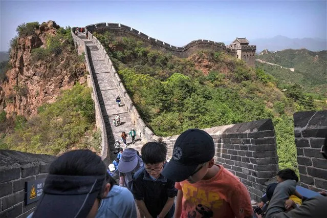 Visitors gather in the shade on a hot day along a stretch of the Jinshanling section of the Great Wall of China, north of Beijing in northern China's Hebei Province, Wednesday, July 5, 2023. (Photo by Mark Schiefelbein/AP Photo)