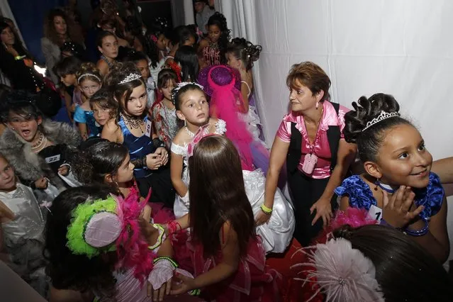 Contestants wait backstage during the “mini-miss” beauty contest in Bobigny, Paris suburb, September 22, 2012. The competition is open for girls aged 7 to 12. (Photo by Benoit Tessier/Reuters)