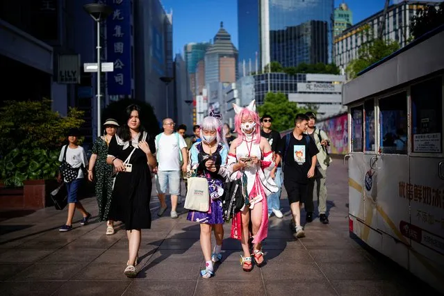 Cosplayers walk on a shopping street, in Shanghai, China on July 31, 2023. (Photo by Aly Song/Reuters)