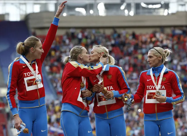Gold medallists team Russia kiss and celebrate at the women's 4x400 metres relay victory ceremony during the IAAF World Athletics Championships at the Luzhniki stadium in Moscow August 17, 2013. From left: Yulia Gushchina, Kseniya Ryzhova, Tatyana Firova and Antonina Krivoshapka. (Photo by Grigory Dukor/Reuters)