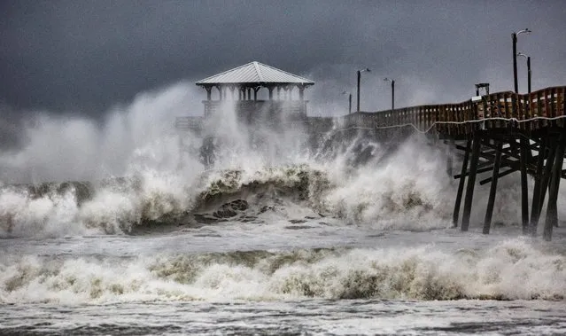 Waves slam the Oceana Pier & Pier House Restaurant in Atlantic Beach, N.C., Thursday, September 13, 2018 as Hurricane Florence approaches the area. (Photo by Travis Long/The News & Observer via AP Photo)