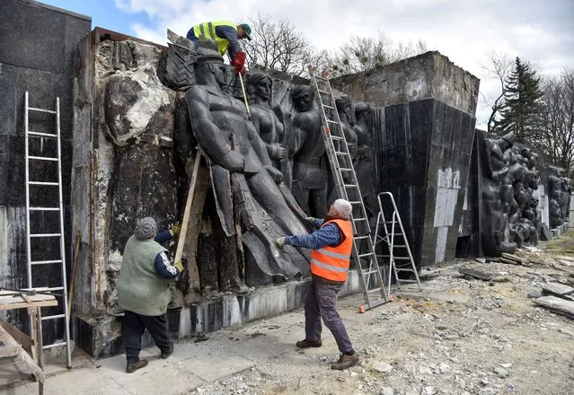 Workers dismantle bas-relief at the Monument to the War Glory of the Soviet Army following a decision by local authorities in Lviv, Ukraine April 23, 2021. (Photo by Pavlo Palamarchuk/Reuters)