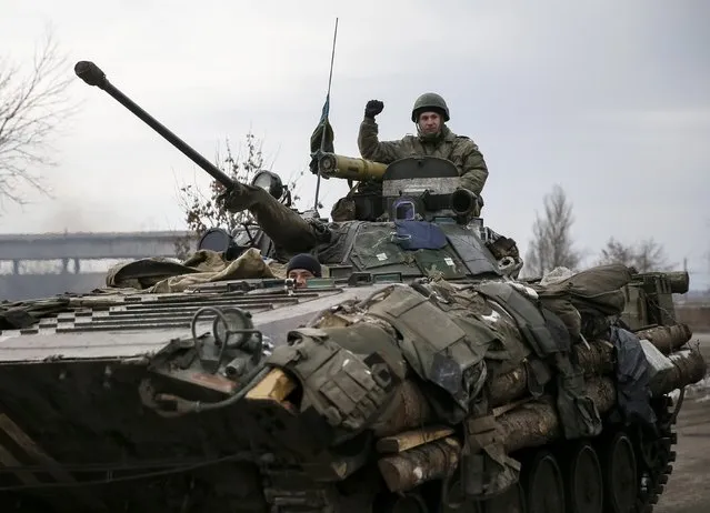 A Ukrainian serviceman rides on a military vehicle near Artemivsk February 19, 2015. (Photo by Gleb Garanich/Reuters)