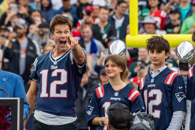 Tom Brady (L) points to someone during a “Thank You” celebration honoring the former New England Patriots’ quarterback during half time of the home opening game for the New England Patriots on September 10, 2023 in Foxborough, Massachusetts. Brady played for 20 seasons with the New England Patriots. (Photo by Joseph Prezioso/AFP Photo)