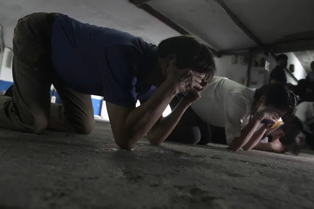 Taiwanese people take cover inside of a basement shelter during the Wanan air raid drill, in Taipei, Taiwan, Monday, July 25, 2022. Taiwan’s capital staged air raid drills Monday and its military mobilized for routine defense exercises, coinciding with concerns over a forceful Chinese response to a possible visit to the island by U.S. Speaker of the House Nancy Pelosi. (Photo by Chiang Ying-ying/AP Photo)
