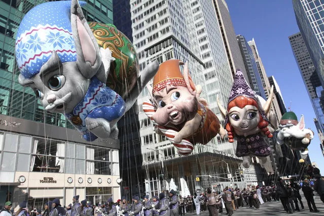 The Fleck, Bjorn, Jojo, and Hugg balloons make their way down New York's Sixth Avenue during the 92nd annual Macy's Thanksgiving Day Parade, Thursday, November 22, 2018, in New York. (Photo by Tina Fineberg/AP Photo)