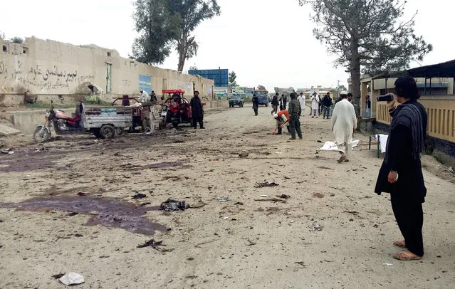 Afghan men inspect the site of a suicide attack in Khost city, Afghanistan, Thursday, April 2, 2015. A suicide bomber attacked an anti-corruption demonstration in eastern Afghanistan on Thursday, killing more than a dozen people and wounding tens, an official said. (Photo by Nasim Liwal/AP Photo)