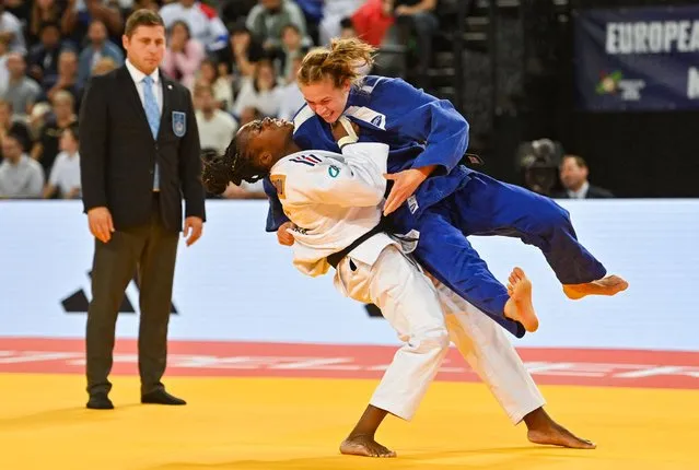 France's Clarisse Agbegnenou (white) throws Finland's Emilia Kanerva (blue) to make an ippon during the women's under 63 kg during the European Judo Championships 2023 at the Sud de France Arena in Montpellier, southern France, on November 4, 2023. (Photo by Sylvain Thomas/AFP Photo)