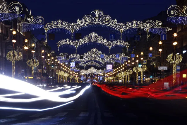 New Year illuminations are seen at the Nevsky Prospect in Saint Petersburg, Russia December 12, 2018. Picture taken with slow shutter speed. (Photo by Anton Vaganov/Reuters)