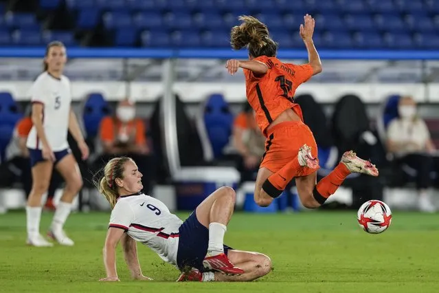 Lindsey Horan (9) of Team United States on the ground while Danielle van de Donk (10) of Team Netherlands is in the air in the second half during the Women's Quarter Final match between Netherlands and United States on day seven of the Tokyo 2020 Olympic Games at International Stadium Yokohama on July 30, 2021 in Yokohama, Kanagawa, Japan. (Photo by Toni L. Sandys/The Washington Post)