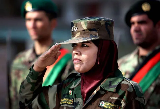 A woman from the Afghan National Army salutes her commander during her graduation ceremony at the Afghan Military Academy in Kabul, Afghanistan, Sunday, February 14, 2016. Over 1700 Afghan National Army (ANA) graduated after receiving a 3-month training program in Kabul. (Photo by Rahmat Gul/AP Photo)