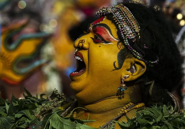 An Indian artist dressed as Hindu goddess Mahakali performs during a procession marking “Bonalu” festival in Hyderabad, India, Monday, August 2, 2021. Bonalu is a month-long Hindu folk festival of the Telangana region dedicated to Kali, the Hindu goddess of destruction. (Photo by Mahesh Kumar A./AP Photo)